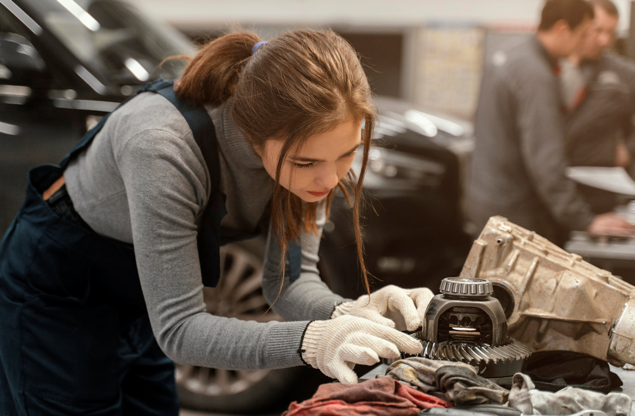 Automotive Technical Training Student Examines a transmission component